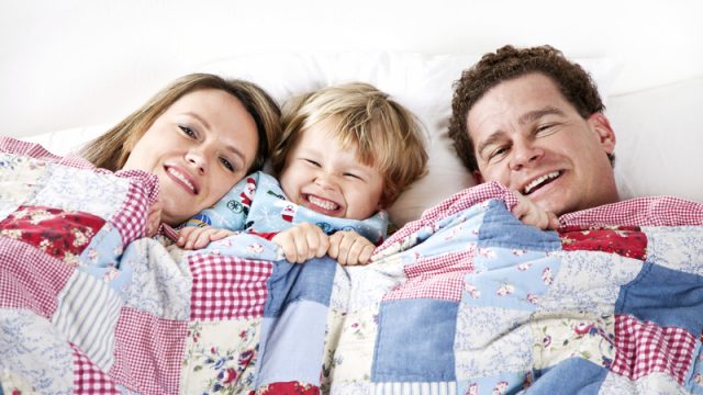 family-snuggling-in-bed