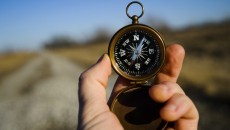 man holding a compass