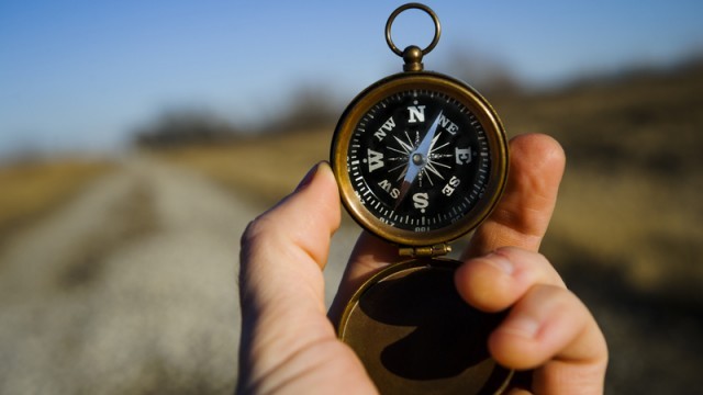 man holding a compass