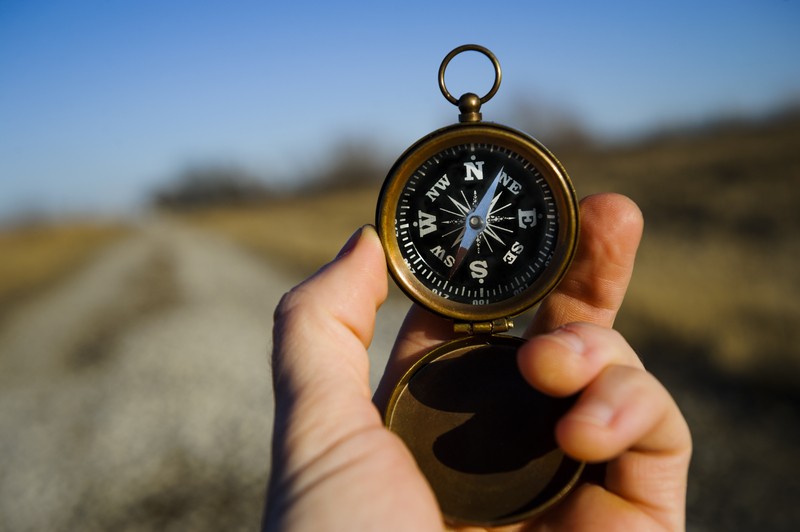 man holding a compass