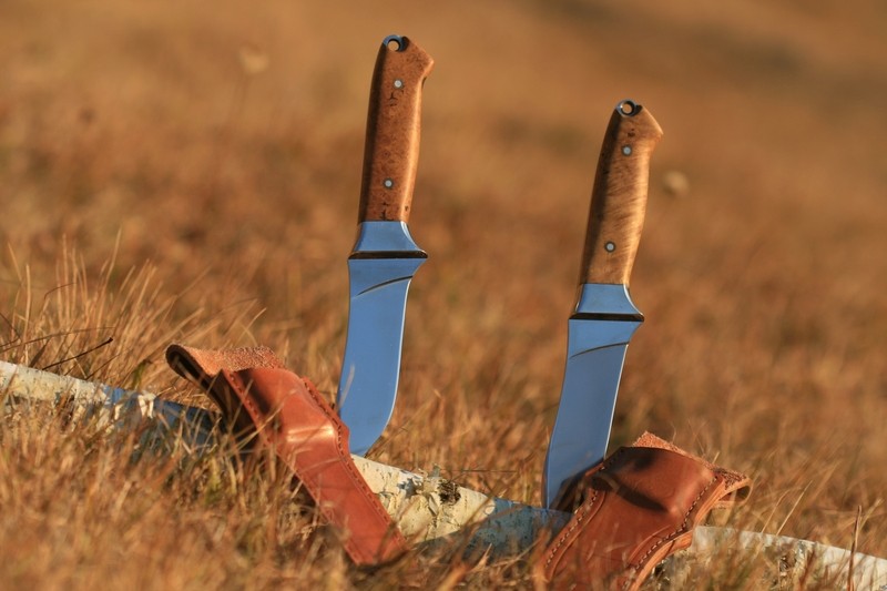 two knives in the grass