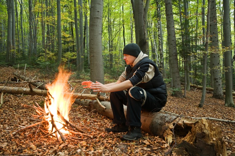 man by the fire in wilderness