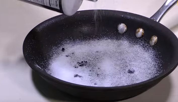 pouring salt on a pan