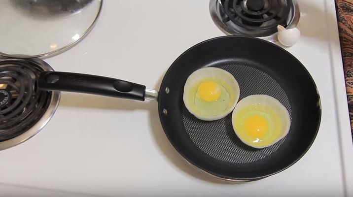 frying an egg in an onion