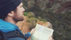 man holding a map in the wilderness