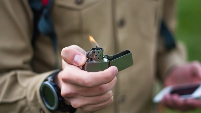 man holding zippo lighter