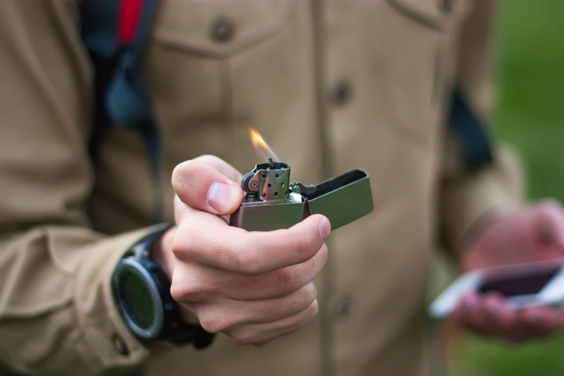 man holding zippo lighter