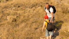 dad and son with backpack on mountain