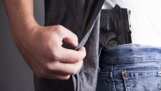 man revealing a firearm