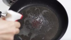 spraying a pan with windex