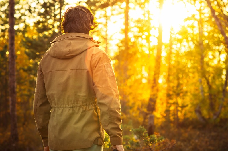 man standing in wilderness