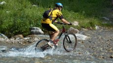 mountain-biker-in-creek