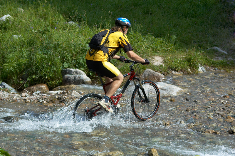 mountain-biker-in-creek