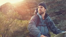 man in wilderness with map