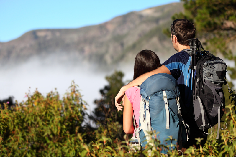 couple hiking with bags