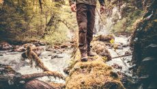 man walking across river