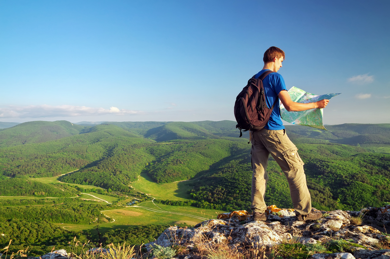 man outside looking at map