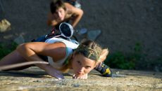 woman and man rock climbing