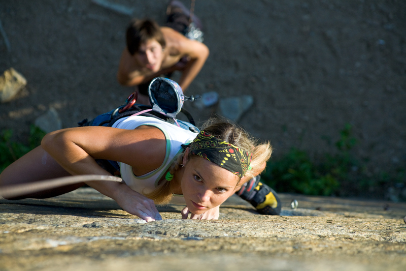 woman and man rock climbing