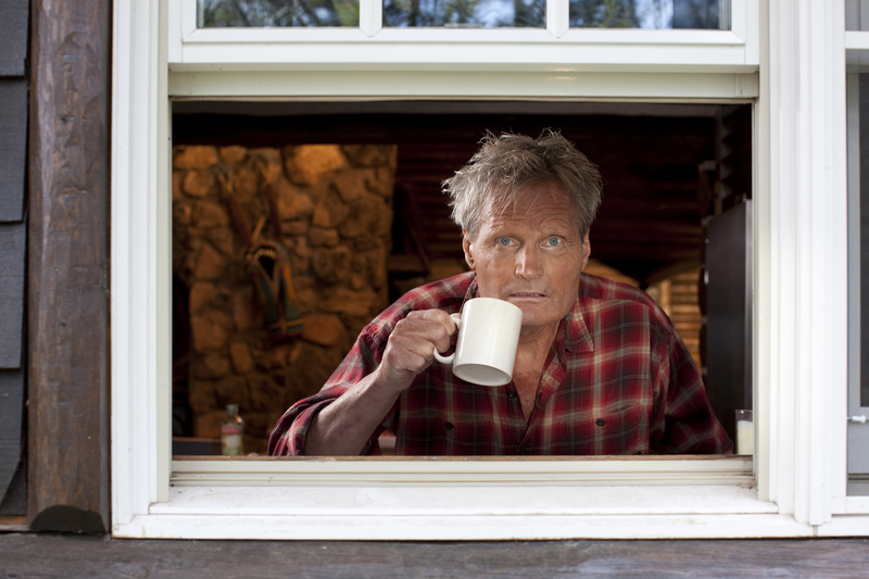 man looking out the window