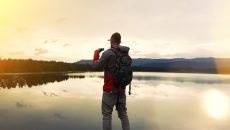 man with backpack and binoculars