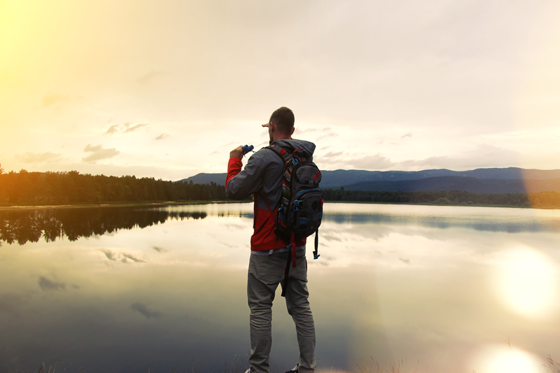 man with backpack and binoculars