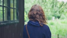 woman at cabin in the woods