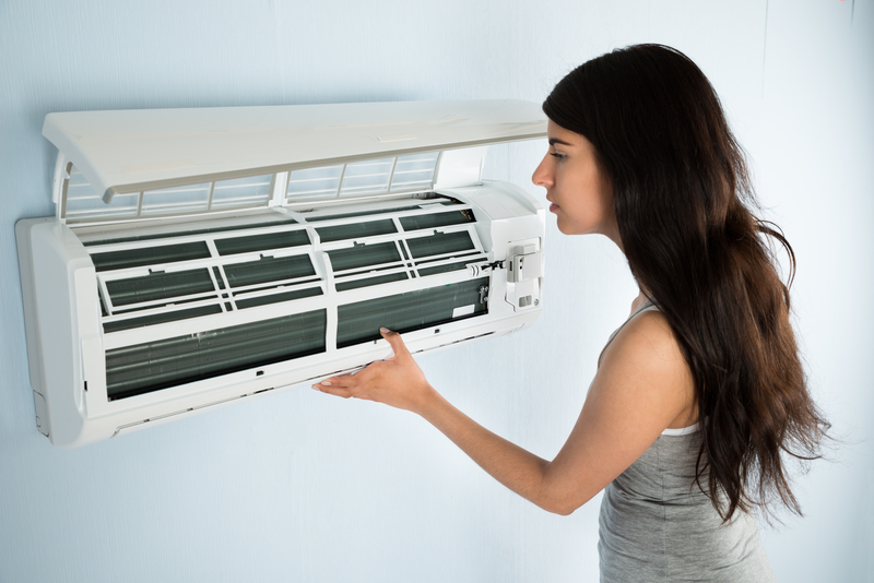 woman checking air conditioner