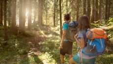 man and woman hiking in woods