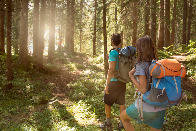 man and woman hiking in woods