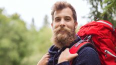 man smiling with backpack