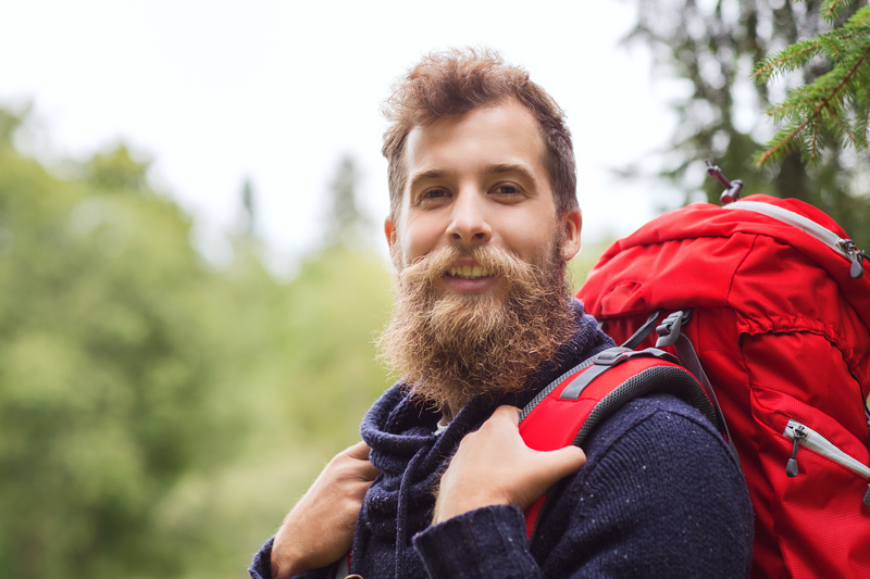 man smiling with backpack