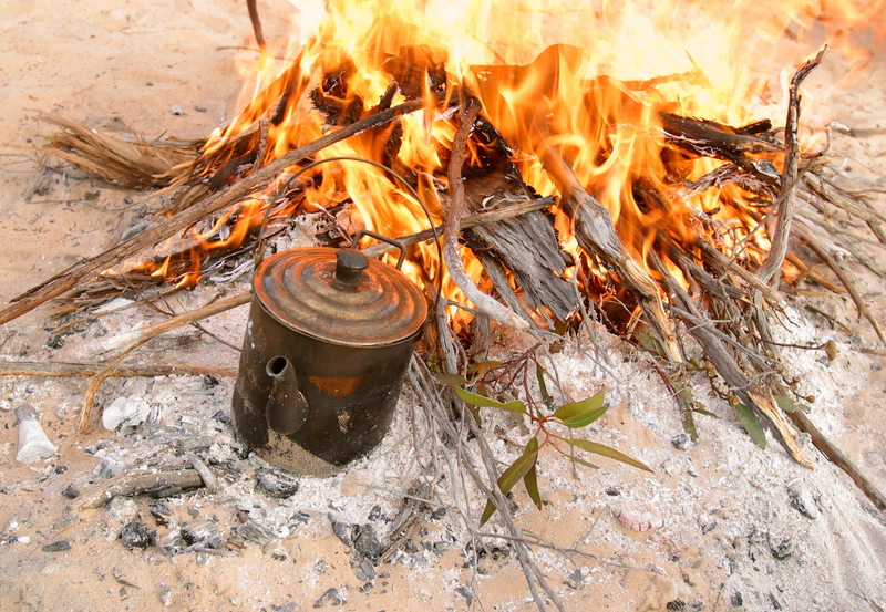 boiling water by fire on the sand