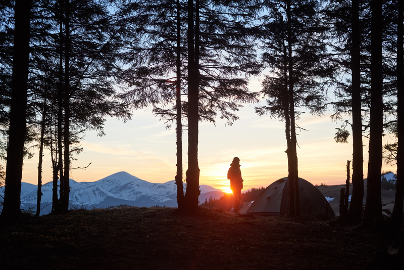 man at sunset camping